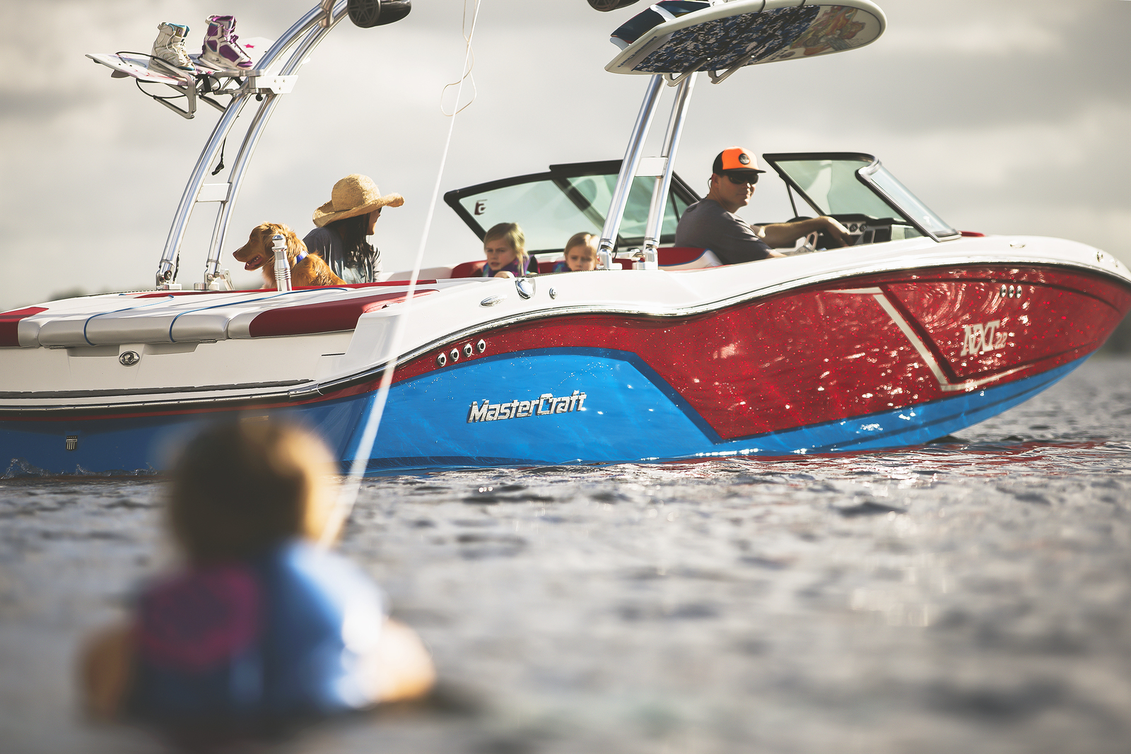 Group towing someone in a MasterCraft boat